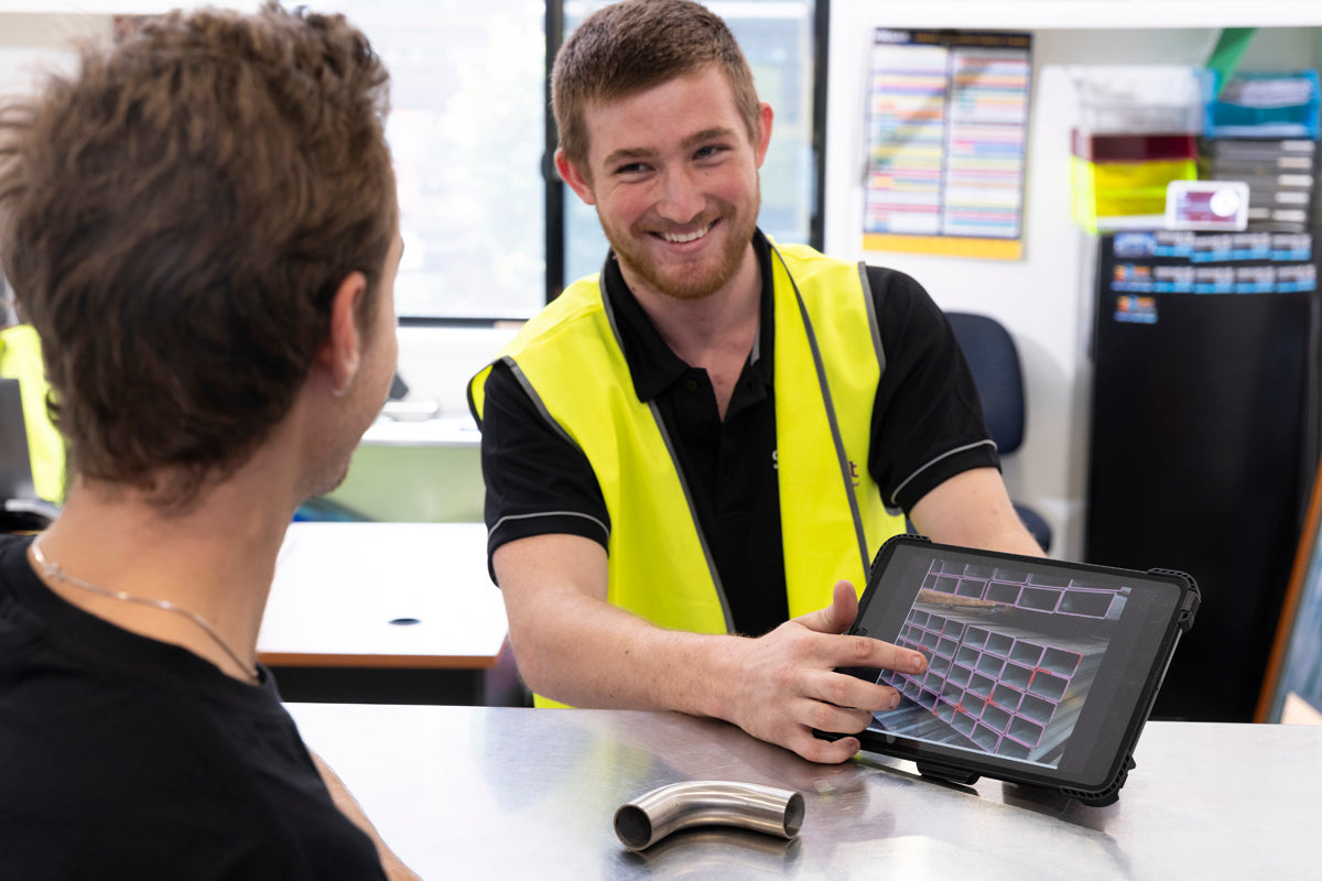 friendly-happy-sales-support-person-helping-customer-buy-steel-products-using-ipad